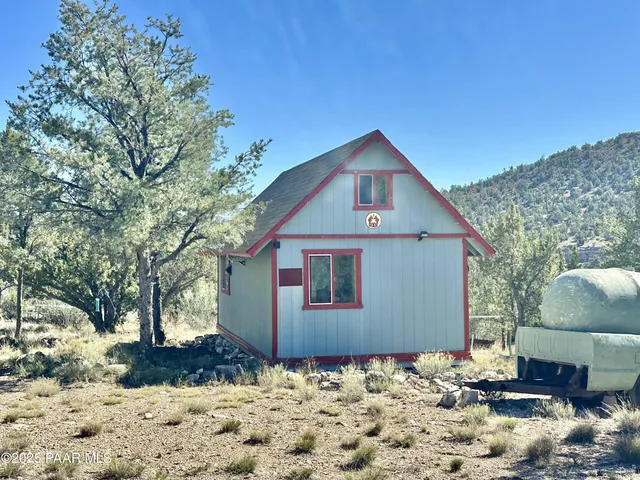 a front view of a house with a yard covered in snow