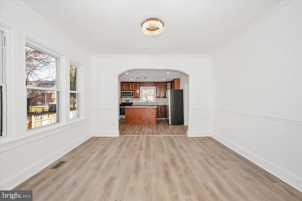 3503 Garrison Boulevard Baltimore, MD 21215 - Photo 11 of 68 a view of a room with wooden floor and windows
