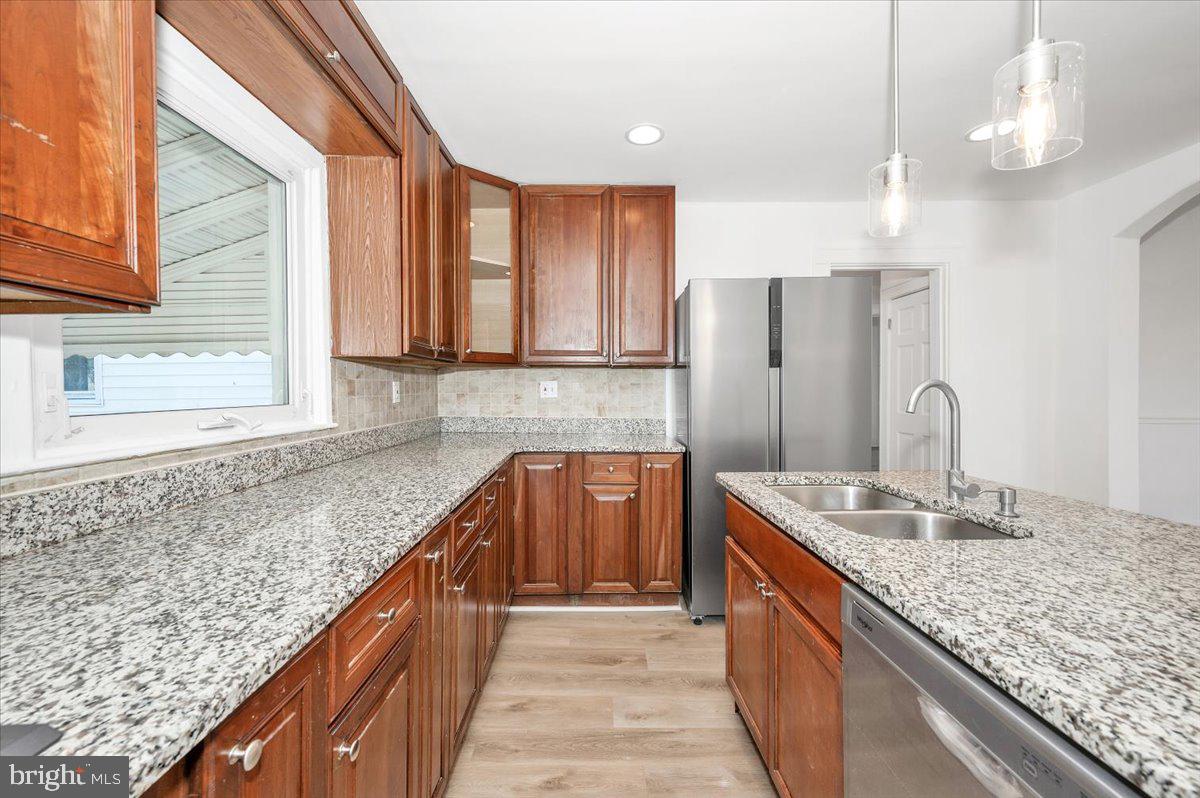 3503 Garrison Boulevard Baltimore, MD 21215 - Photo 18 of 68 a kitchen with stainless steel appliances granite countertop a sink stove and refrigerator