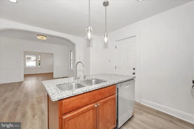 a view of empty room with wooden floor and ceiling fan