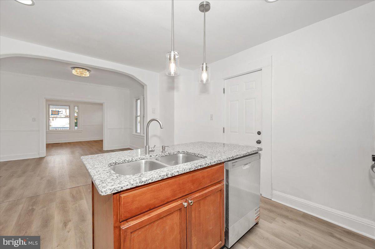 3503 Garrison Boulevard Baltimore, MD 21215 - Photo 20 of 68 a bathroom with a granite countertop sink and a mirror
