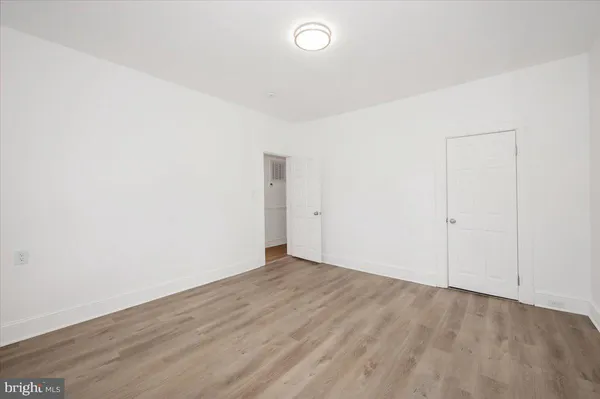 a view of hallway with wooden floor