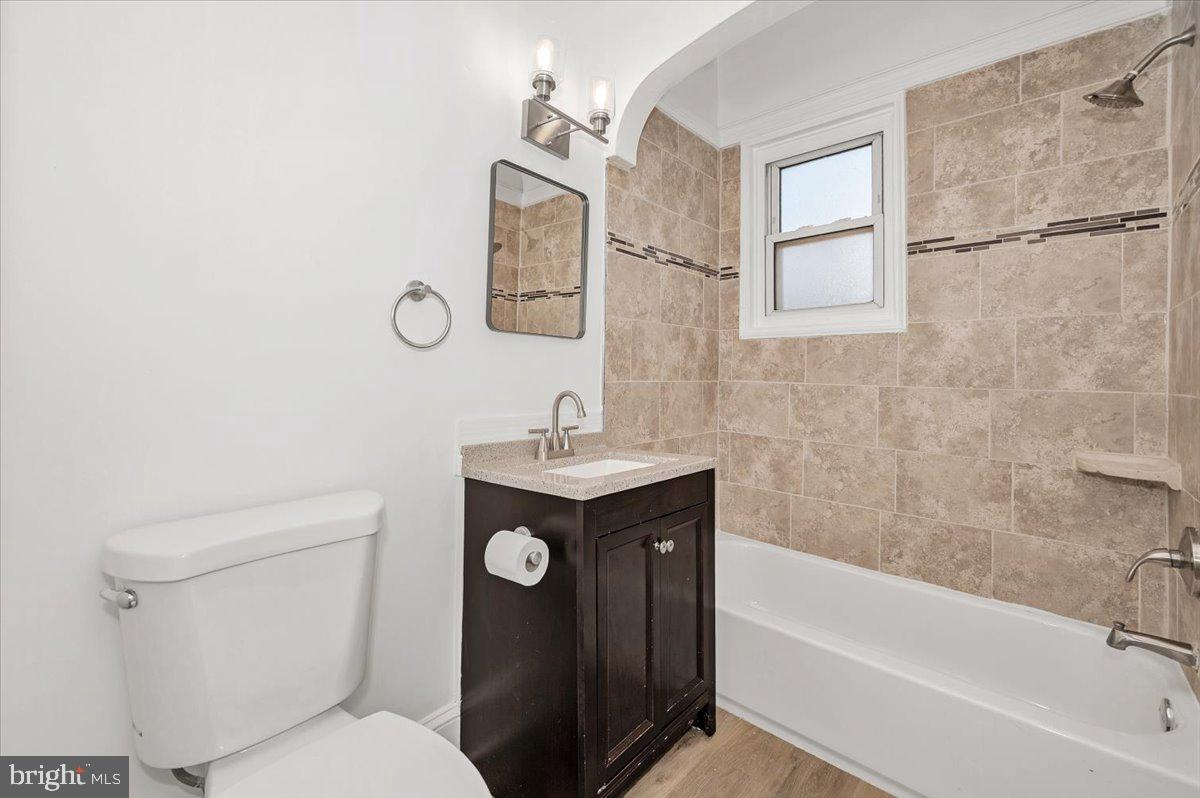 3503 Garrison Boulevard Baltimore, MD 21215 - Photo 30 of 68 a bathroom with a sink toilet and shower
