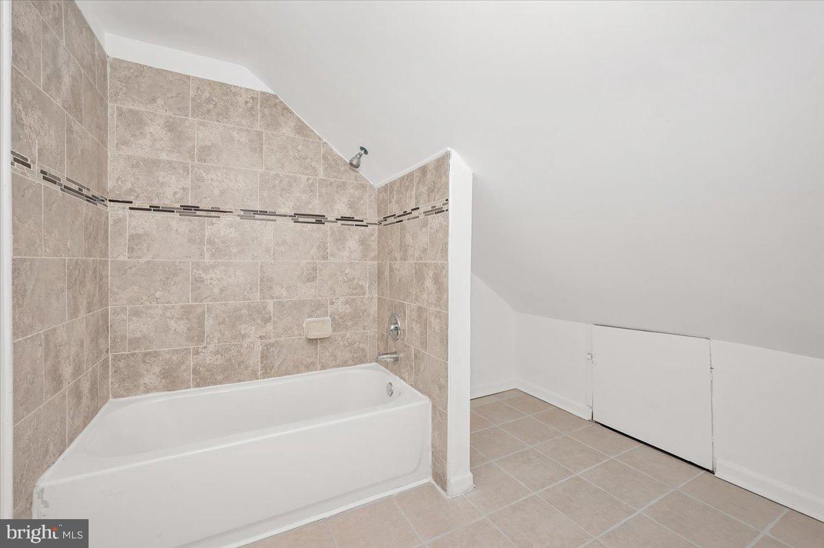 3503 Garrison Boulevard Baltimore, MD 21215 - Photo 45 of 68 a bathroom with a bathtub and a shower