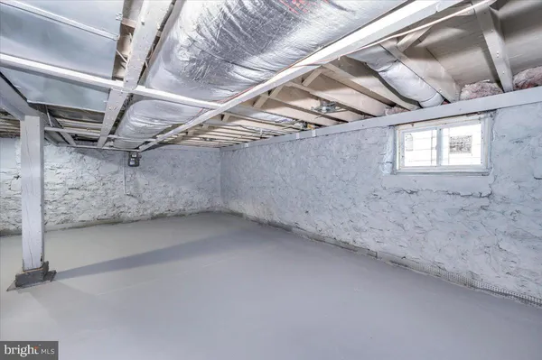 a view of a white house with a large tree with wooden fence