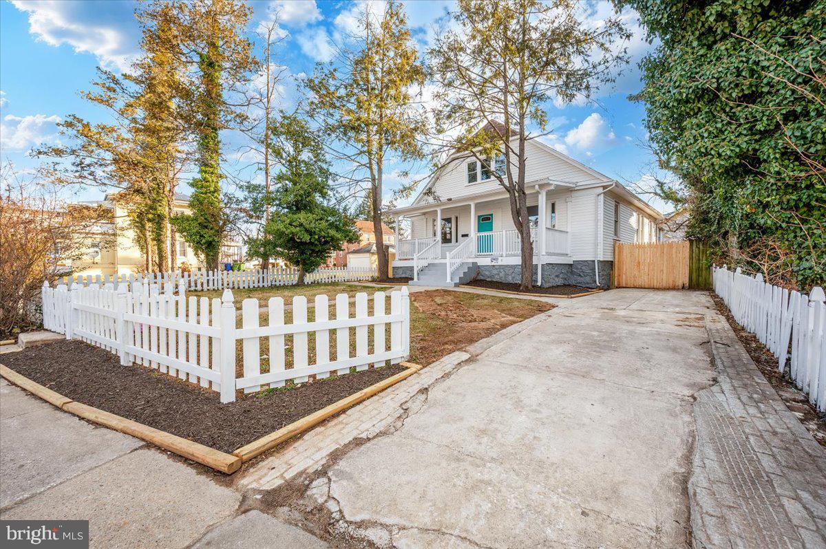 3503 Garrison Boulevard Baltimore, MD 21215 - Photo 66 of 68 a view of a house with a small yard and wooden fence