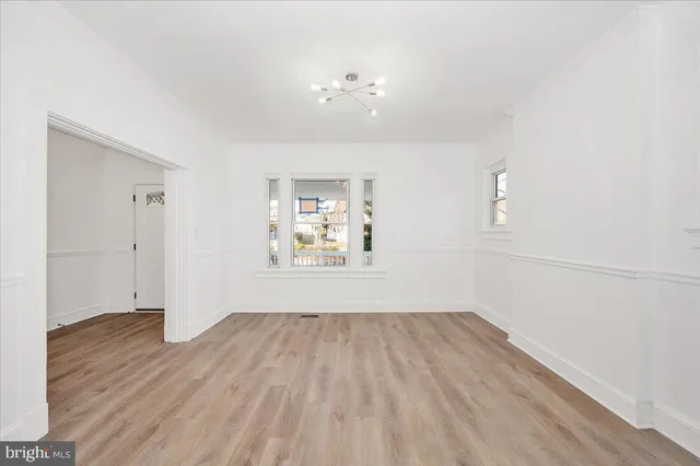a view of a room with wooden floor and windows