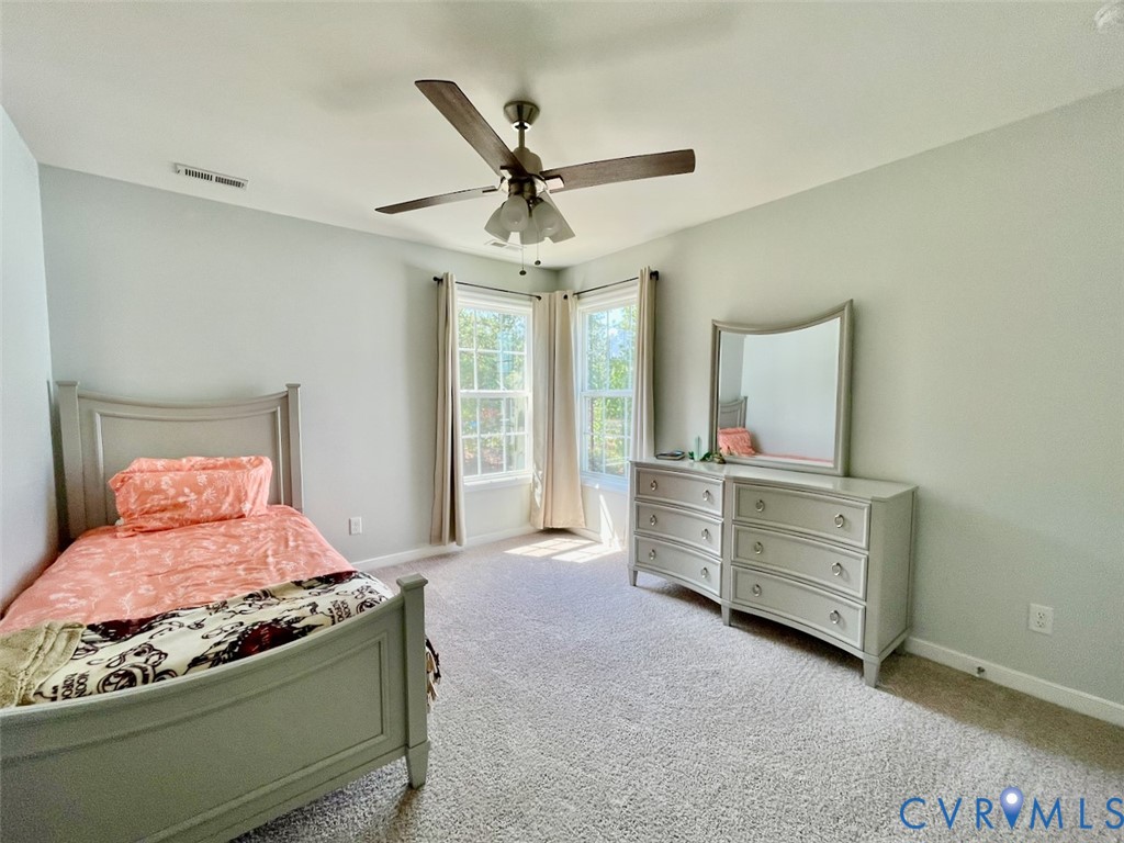 9506 Simonsville Road Midlothian, VA 23112 - Photo 20 of 27 a bedroom with a bed and a dresser