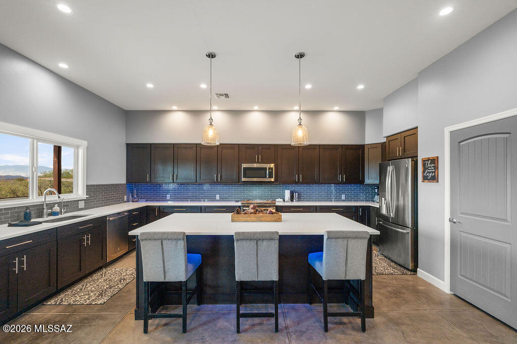 16276 East Empire View Road Vail, AZ 85641 - Photo 15 of 51 a kitchen with a refrigerator a sink a counter top space and a center island
