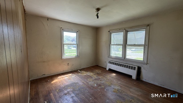 131 Bryden Terrace Hamden, CT 06517 - Photo 7 of 16 a view of an empty room with wooden floor and a window
