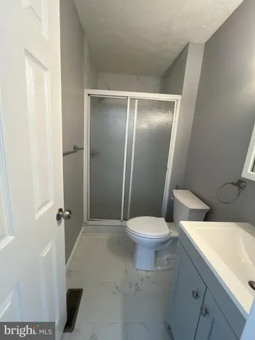 a white toilet sitting next to a bathroom sink