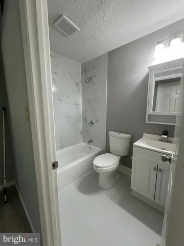 a bathroom with a toilet a sink and bathtub
