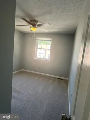 a view of a house with large windows and a small yard