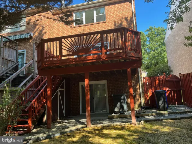 a view of a backyard with wooden fence