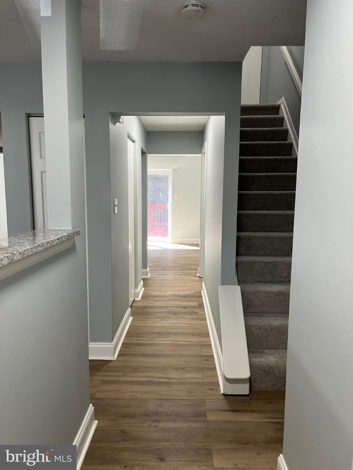 8523 Pine Run Court Ellicott City, MD 21043 - Photo 3 of 18 a view of hallway with stairs and wooden floor