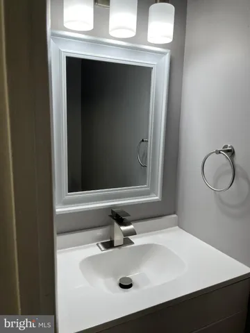 a bathroom with a sink vanity and a mirror