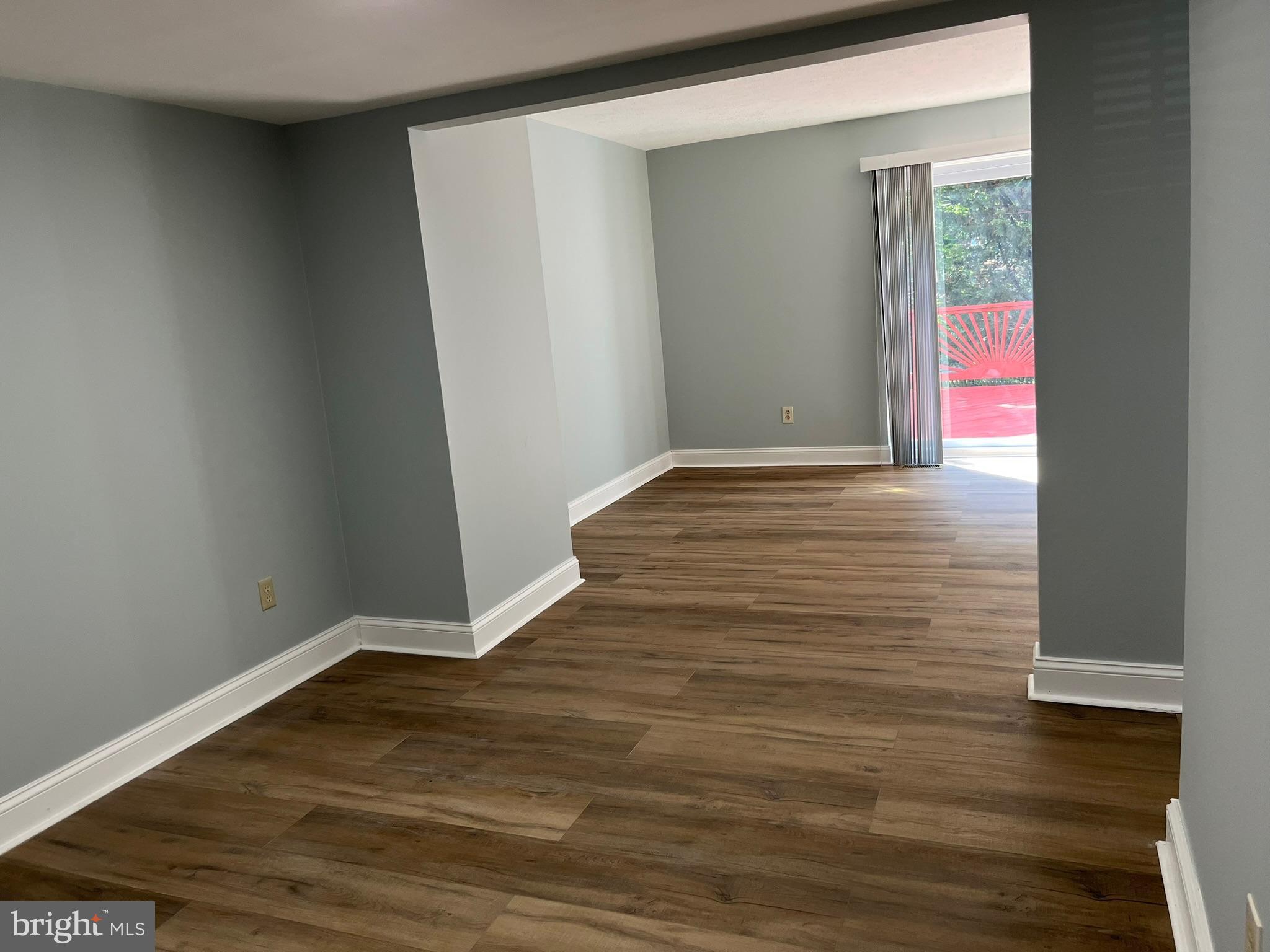8523 Pine Run Court Ellicott City, MD 21043 - Photo 5 of 18 a view of an empty room with wooden floor and a window
