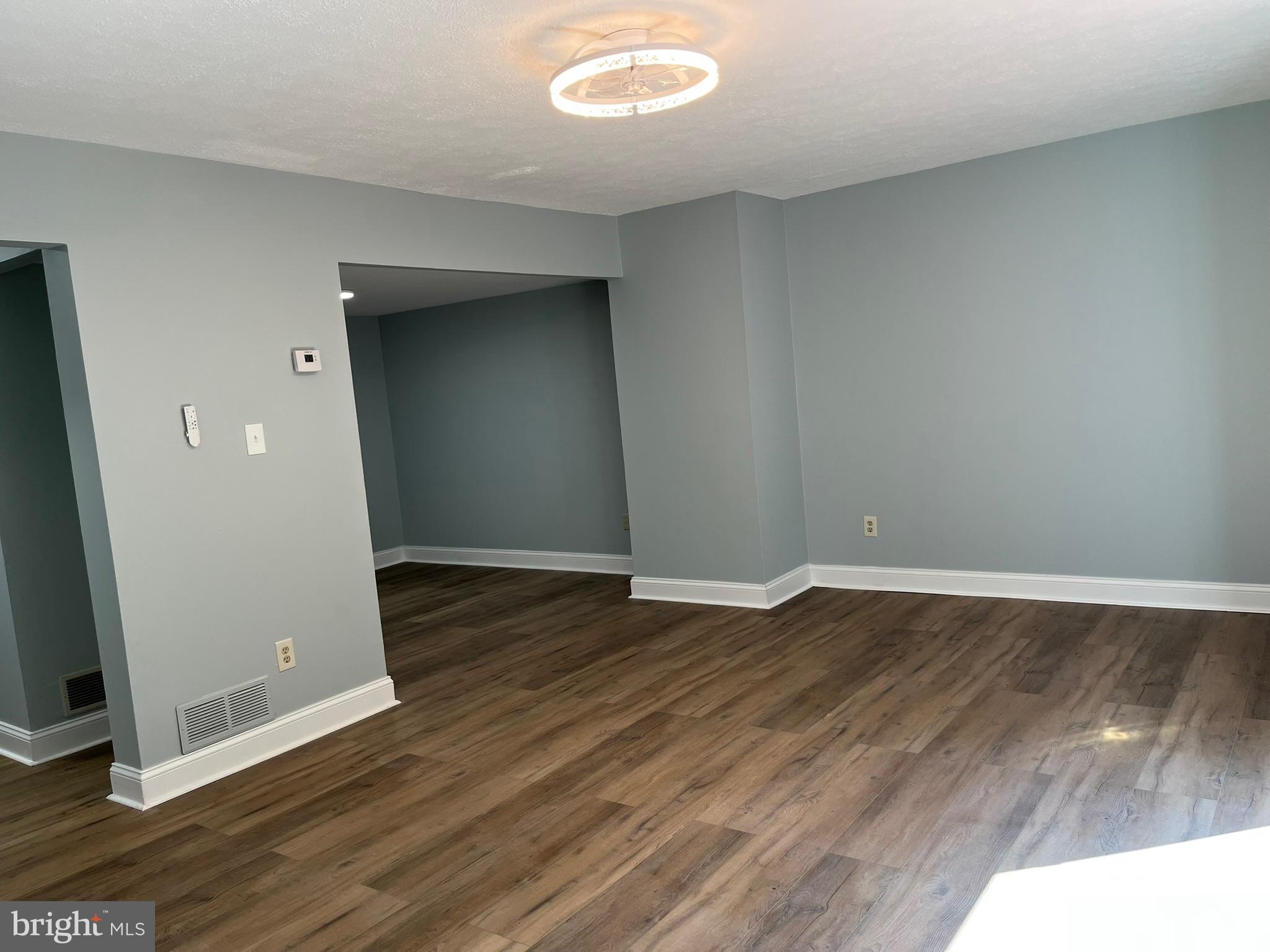 8523 Pine Run Court Ellicott City, MD 21043 - Photo 6 of 18 an empty room with wooden floor and entrance