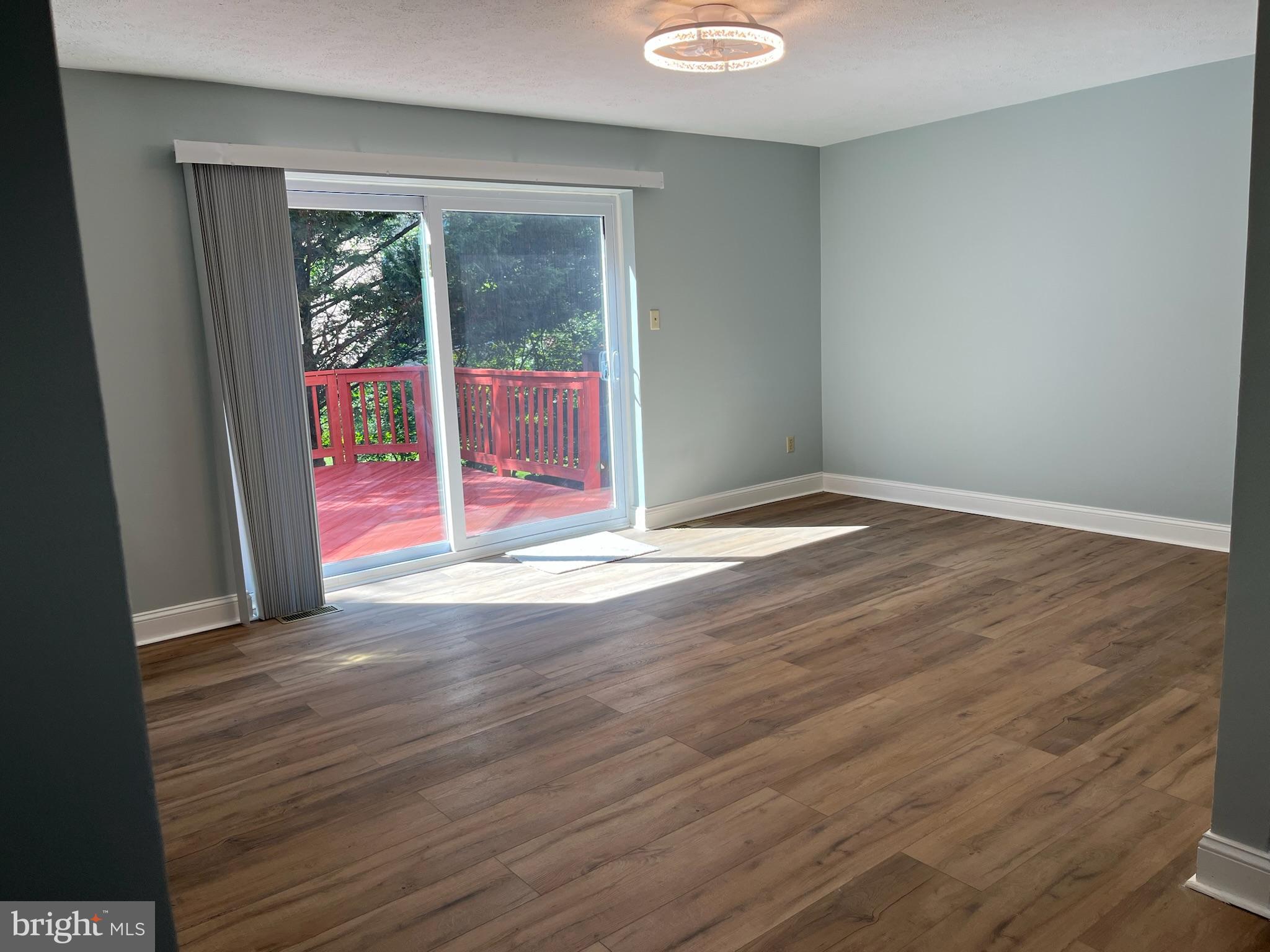 8523 Pine Run Court Ellicott City, MD 21043 - Photo 7 of 18 an empty room with wooden floor and windows