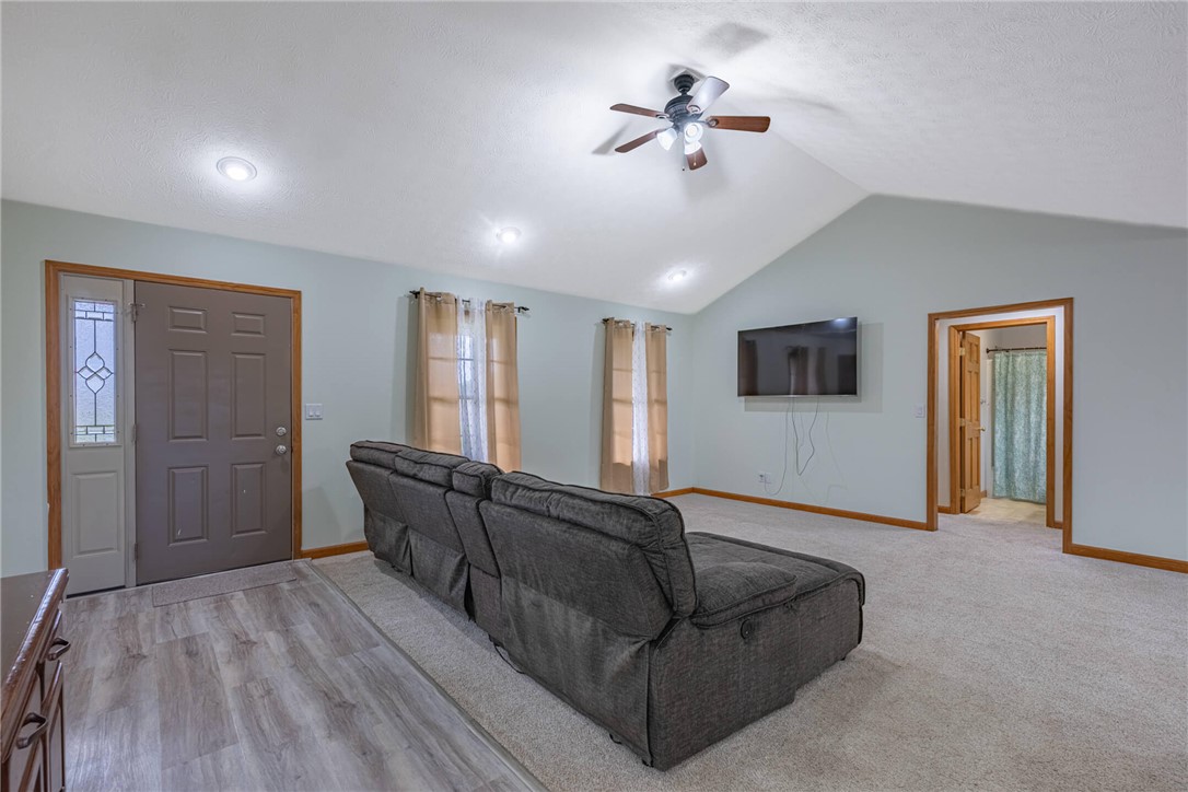 2645 Vance Road St. Paris, OH 43072 - Photo 3 of 35 This generous living room features vaulted ceilings and varied flooring, creating an inviting atmosphere.