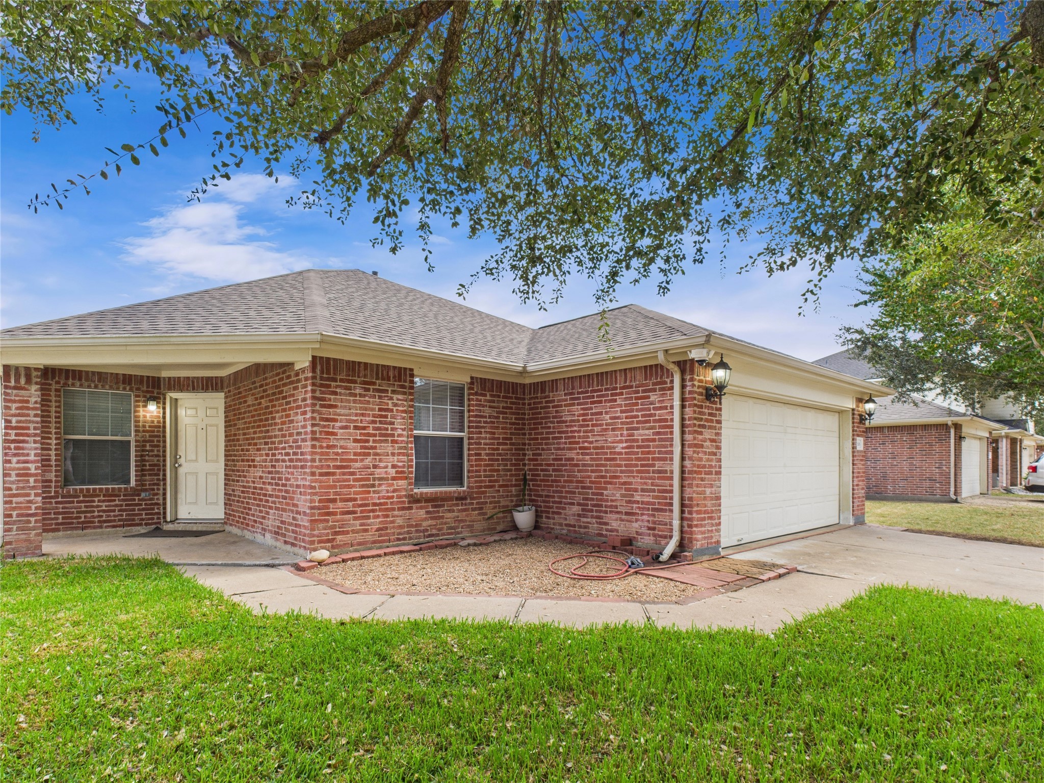 6618 Portlick Drive Katy, TX 77449 - Photo 26 of 40 Side view showing spacious driveway and front yard landscaping.