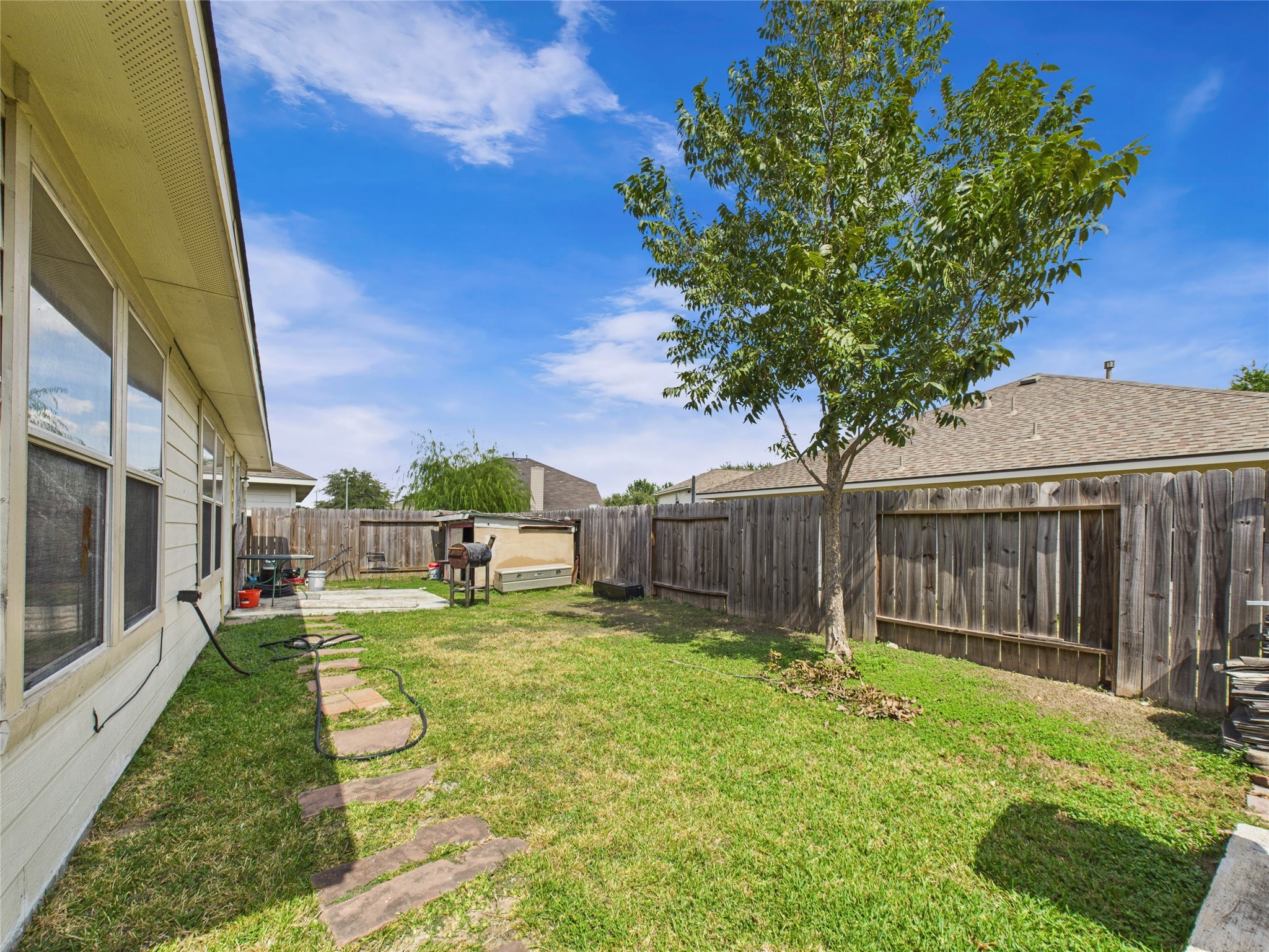 6618 Portlick Drive Katy, TX 77449 - Photo 28 of 40 Fenced backyard with green space, ideal for outdoor living and entertaining.