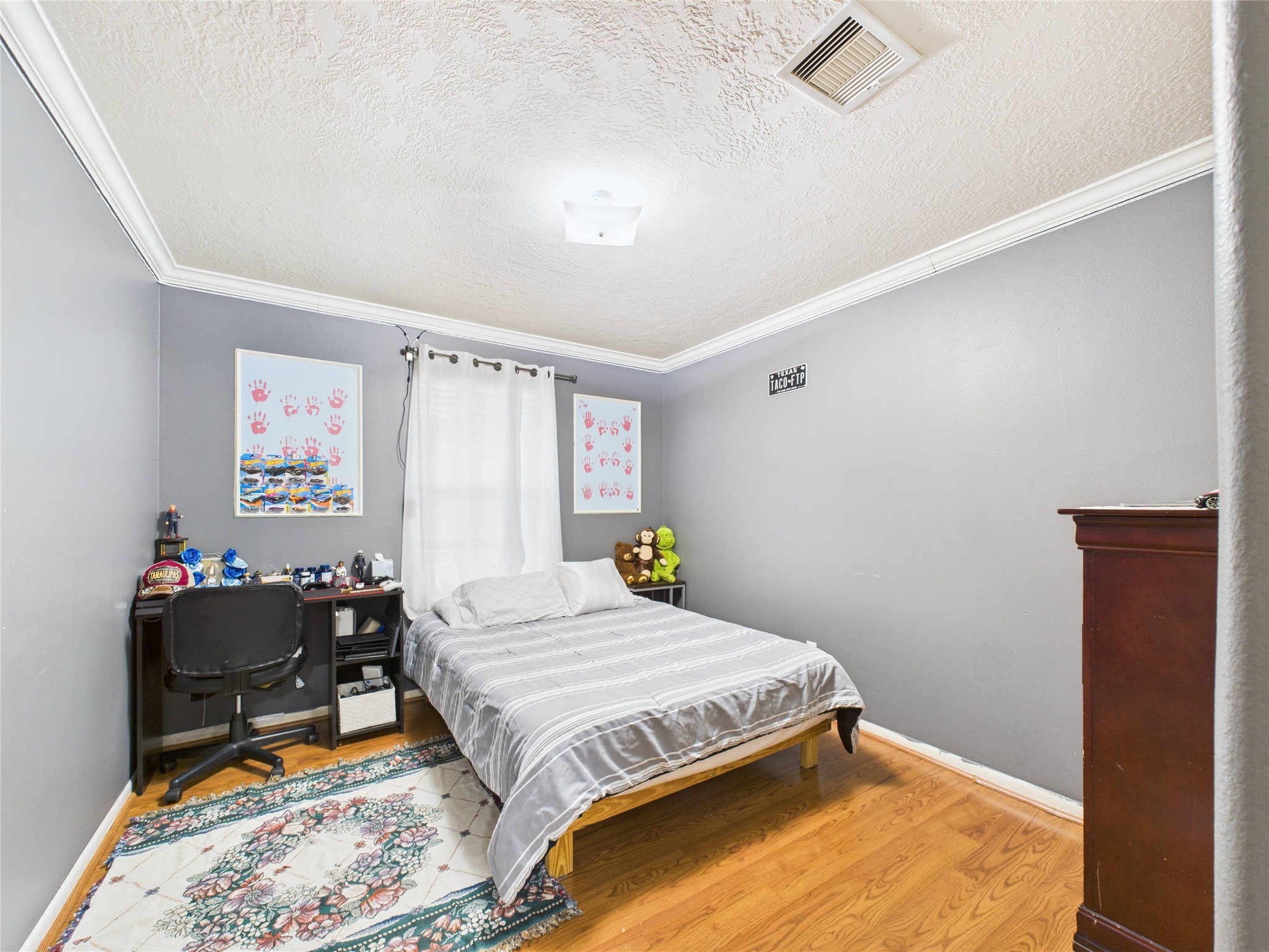 6618 Portlick Drive Katy, TX 77449 - Photo 3 of 40 Spacious bedroom featuring wood flooring and crown molding.
