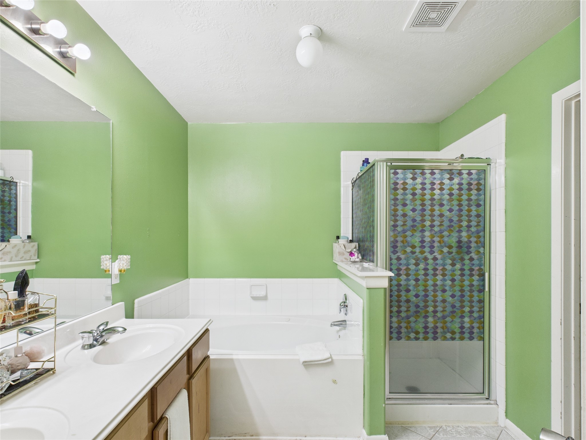 6618 Portlick Drive Katy, TX 77449 - Photo 36 of 40 Primary bath features dual vanities, soaking tub, and separate shower.