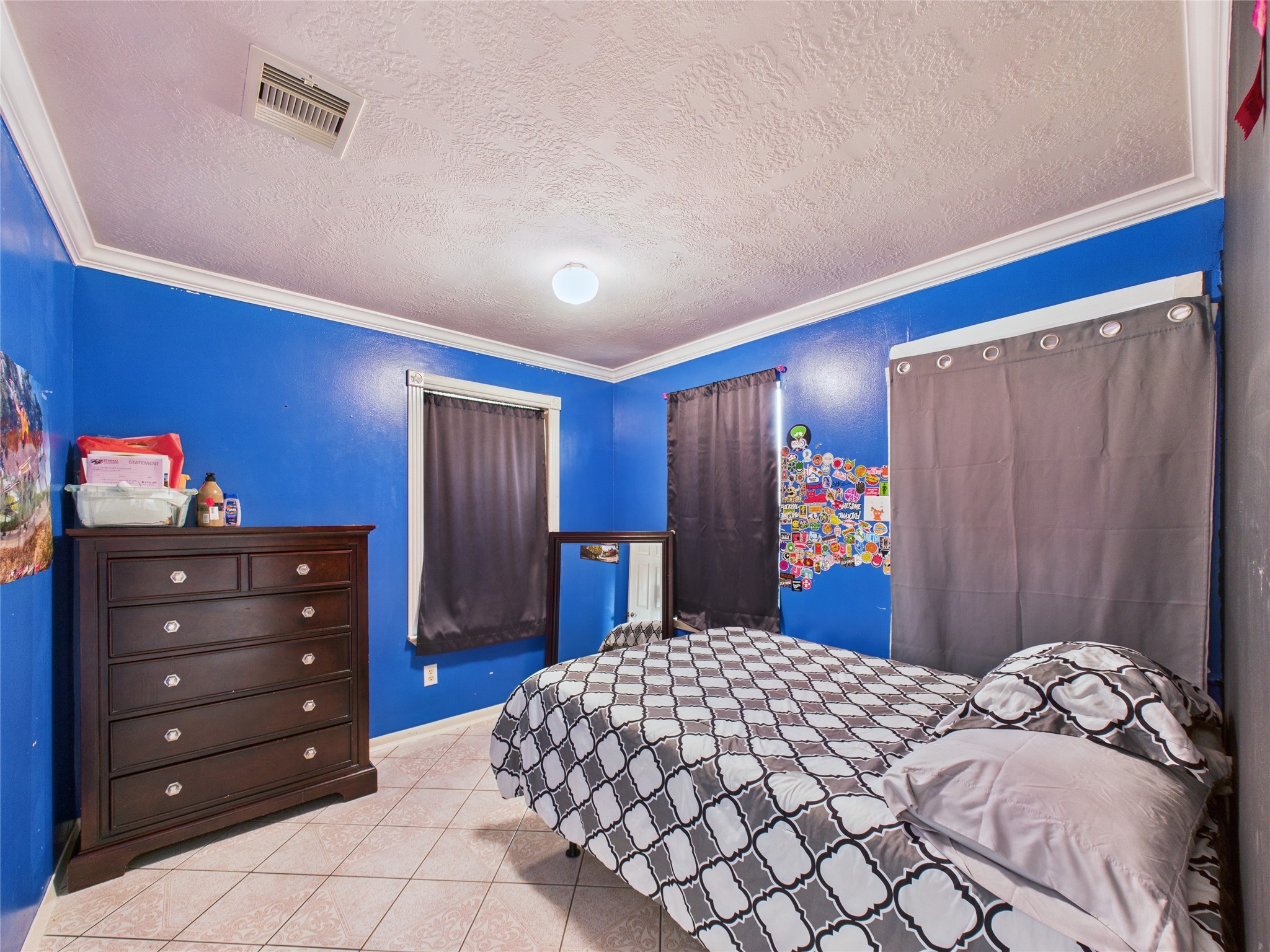 6618 Portlick Drive Katy, TX 77449 - Photo 39 of 40 Versatile bedroom with tile floors and bold accent wall, perfect as a guest room or office.