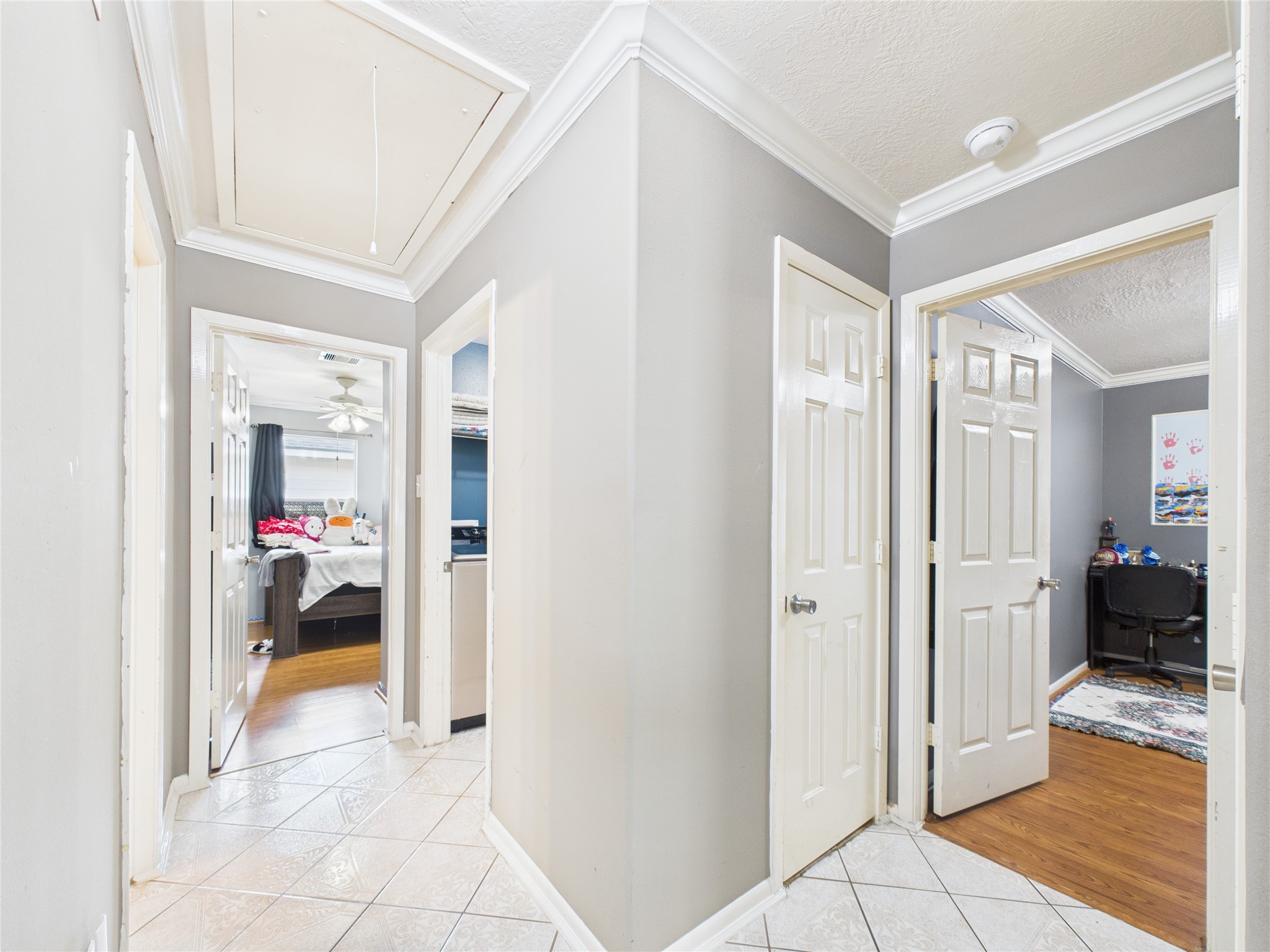 6618 Portlick Drive Katy, TX 77449 - Photo 5 of 40 Bright hallway connecting bedrooms and living areas with neutral tile floors.
