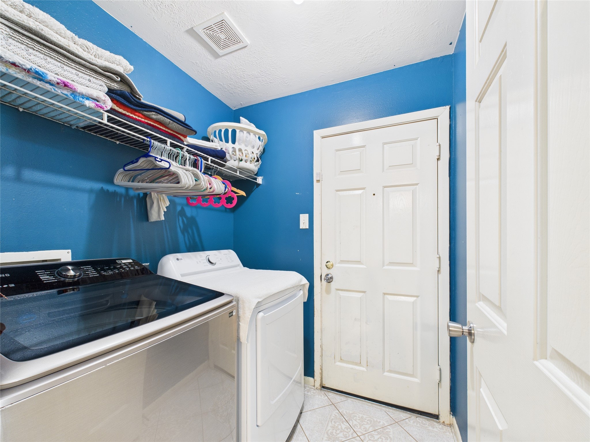 6618 Portlick Drive Katy, TX 77449 - Photo 7 of 40 Dedicated laundry room with shelving and direct garage access.