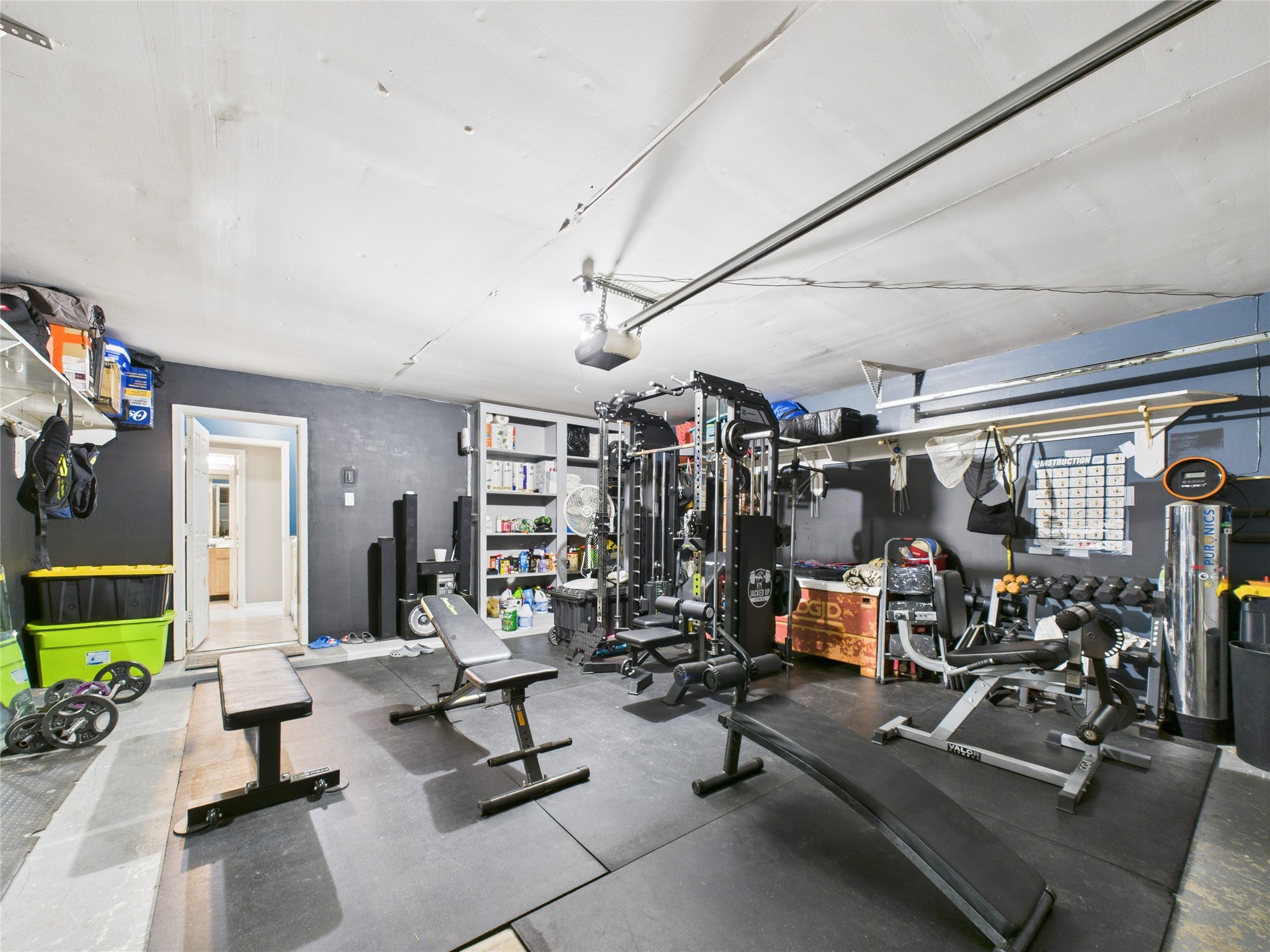 6618 Portlick Drive Katy, TX 77449 - Photo 8 of 40 Two-car garage currently used as a home gym with ample storage options.