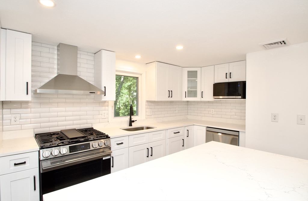 7 Barbara Road Kingston, MA 02364 - Photo 6 of 26 a kitchen with a stove and a microwave