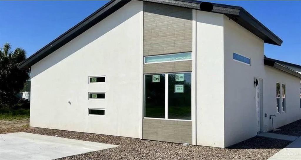 View of side of home featuring stucco siding