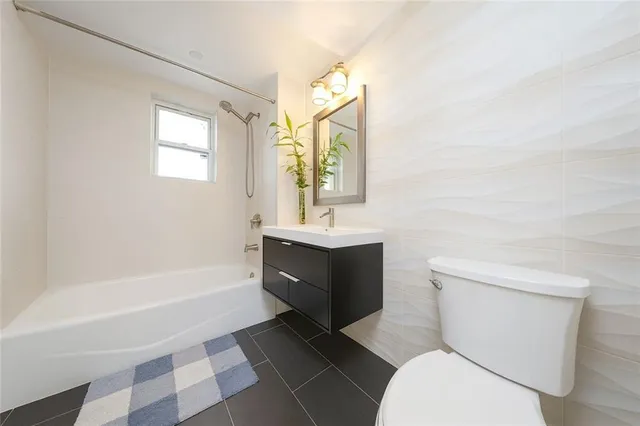 a bathroom with a sink a toilet and bathtub