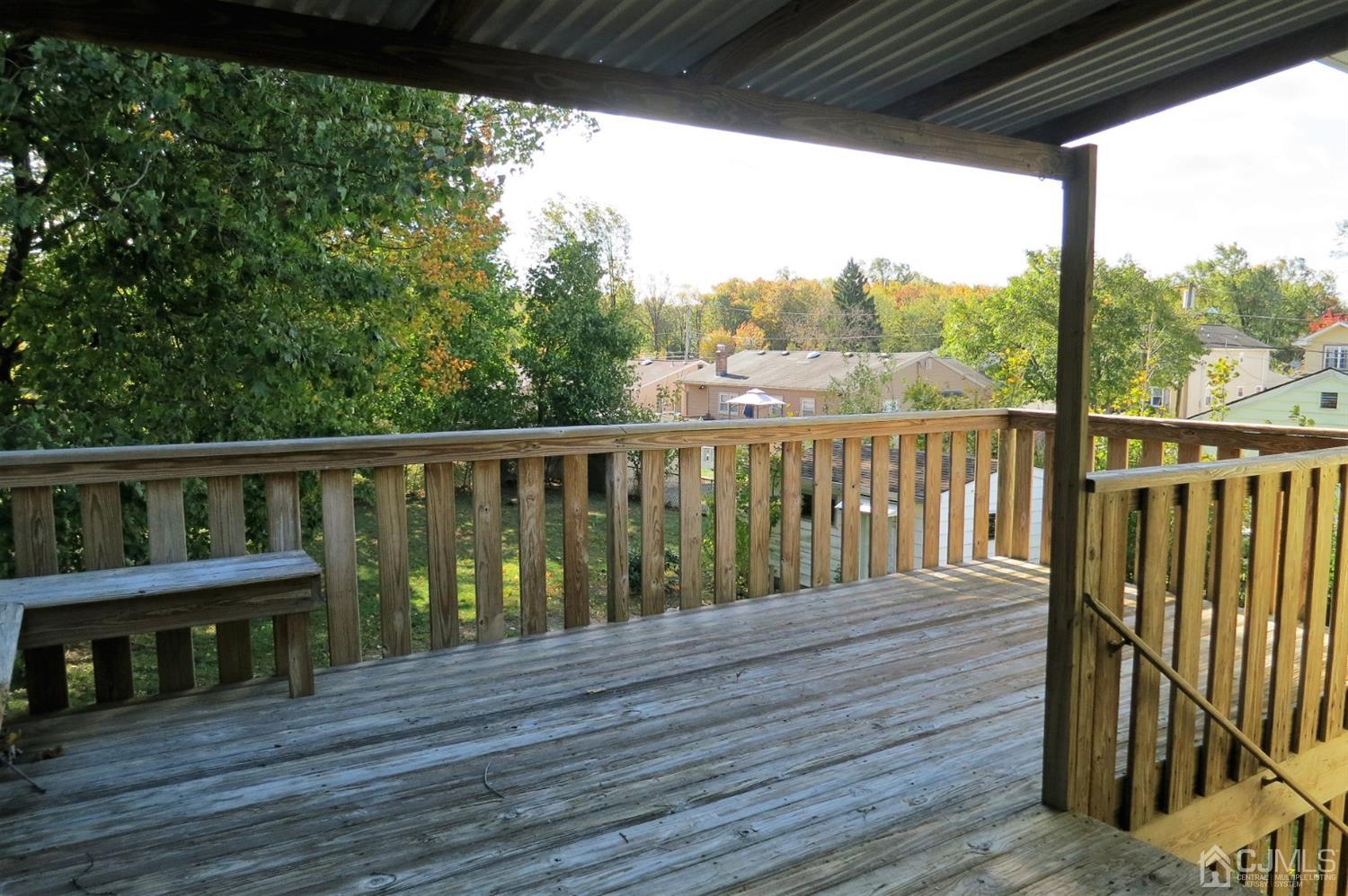 145 Lafayette Road Fords, NJ 08863 - Photo 11 of 18 a balcony with wooden floor outdoor seating and yard in the back