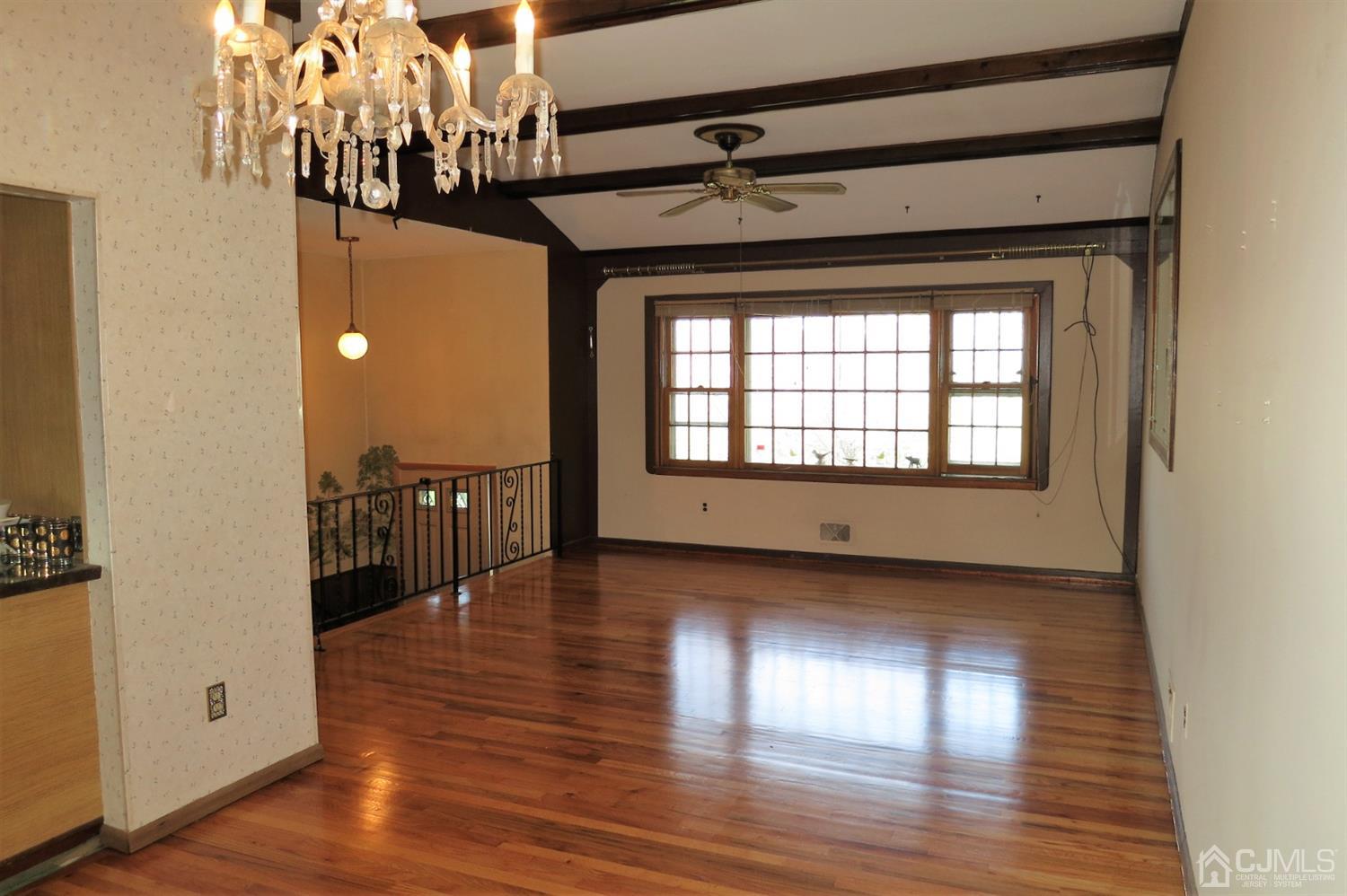 145 Lafayette Road Fords, NJ 08863 - Photo 3 of 18 a view of a room with wooden floor a ceiling fan and windows