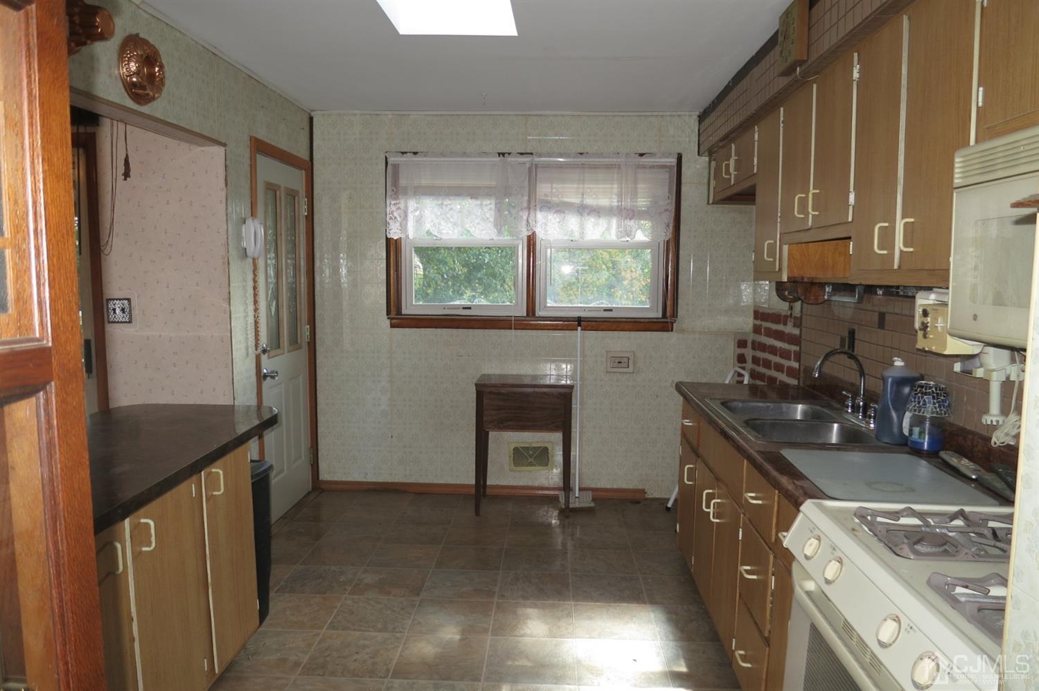 145 Lafayette Road Fords, NJ 08863 - Photo 7 of 18 a kitchen with a sink stove and refrigerator