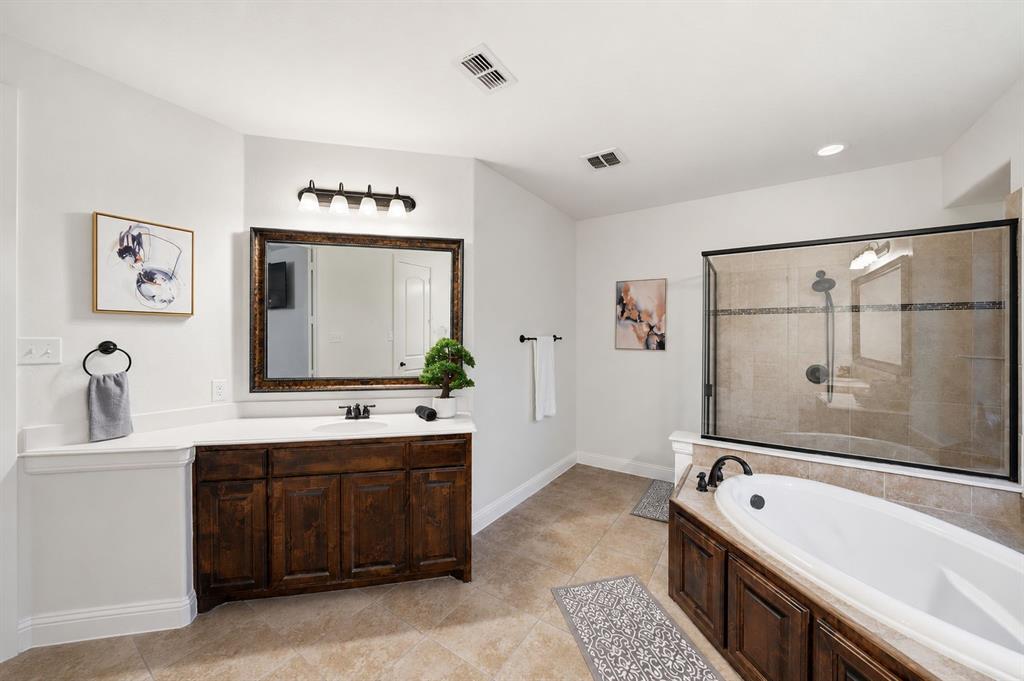 624 Sorrell Road McKinney, TX 75072 - Photo 14 of 28 a spacious bathroom with a tub sink and mirror