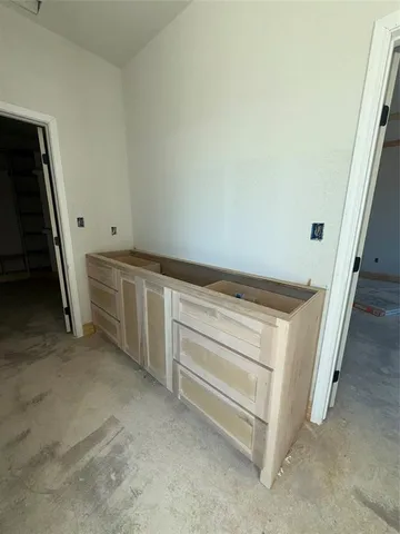 a view of an empty room with storage