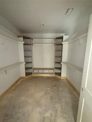a view of an empty room with closet