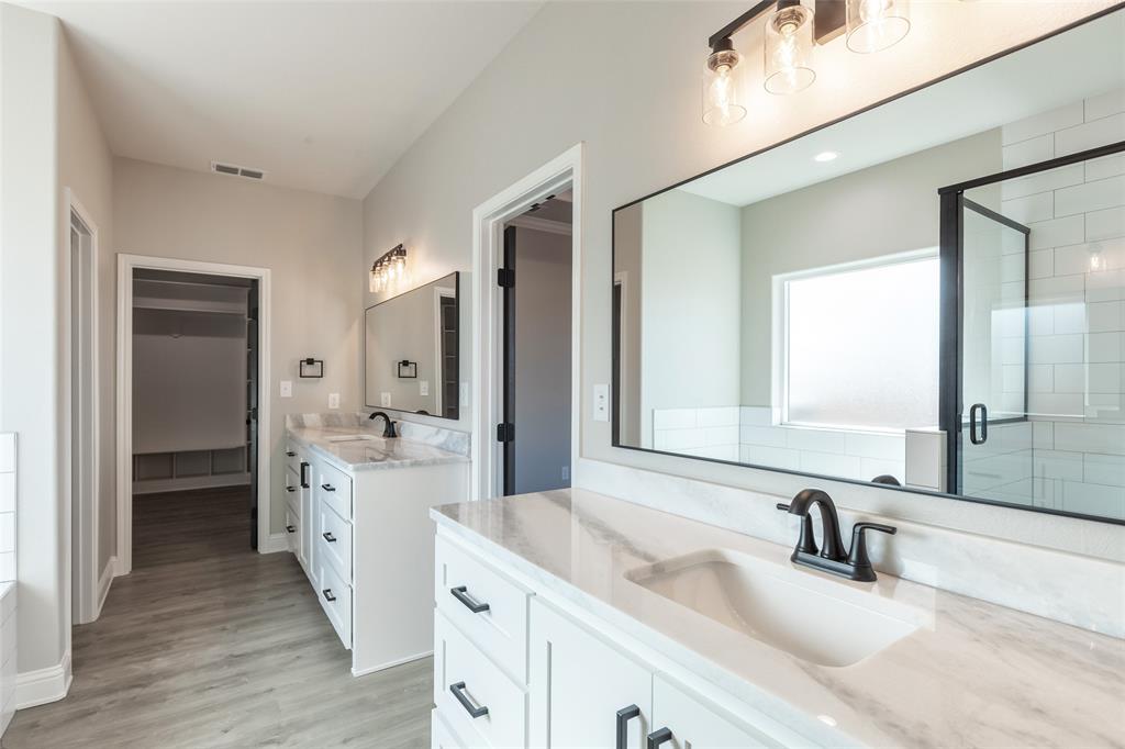 239 Indian Ridge Road Tuscola, TX 79562 - Photo 12 of 37 a bathroom with a double vanity sink mirror and double