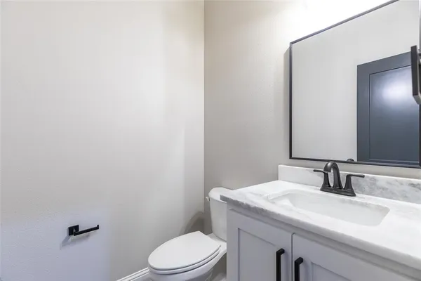 a large kitchen with stainless steel appliances kitchen island a large counter top a stove a chimney a sink and a refrigerator