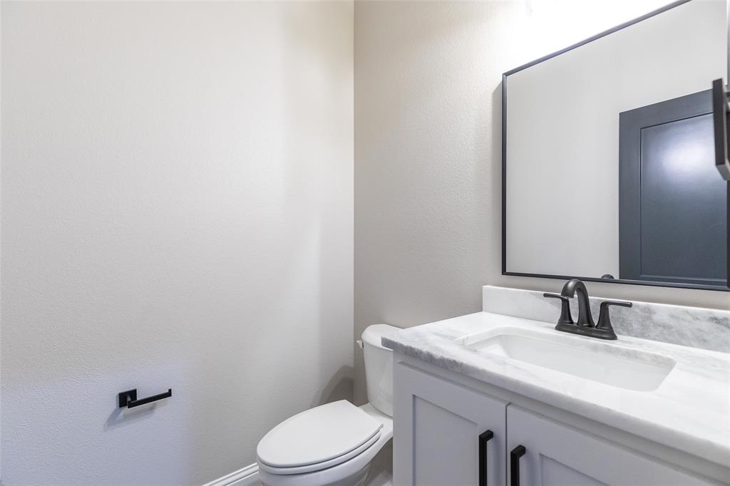239 Indian Ridge Road Tuscola, TX 79562 - Photo 16 of 37 a bathroom with a sink a toilet and mirror