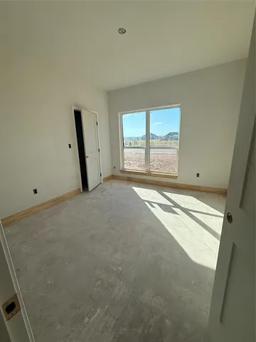 a bathroom with a granite countertop sink and a tub