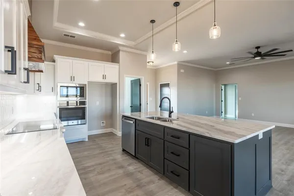 a view of kitchen and living room with wooden floor