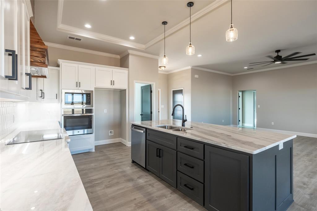 239 Indian Ridge Road Tuscola, TX 79562 - Photo 18 of 37 a large kitchen with kitchen island a sink a counter space stainless steel appliances and cabinets