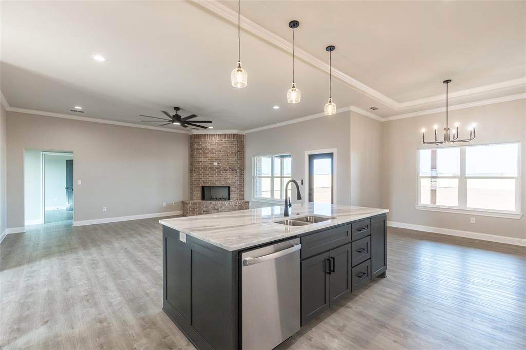 239 Indian Ridge Road Tuscola, TX 79562 - Photo 20 of 37 a kitchen with a stove a window and wooden floor