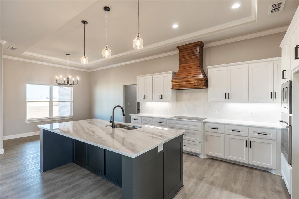239 Indian Ridge Road Tuscola, TX 79562 - Photo 21 of 37 a kitchen with a sink center island and wooden floor