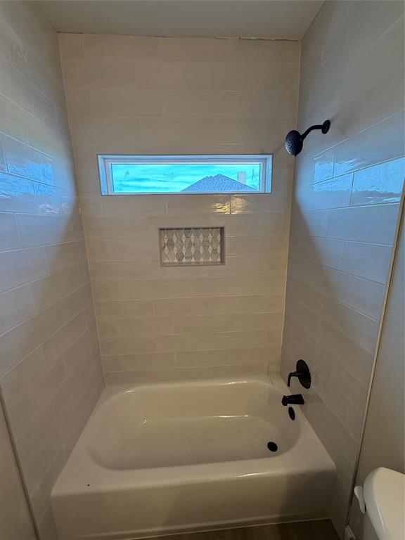 239 Indian Ridge Road Tuscola, TX 79562 - Photo 22 of 26 a bathroom with a bathtub and a shower